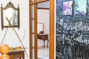 a chalkboard wall with writing on it in a room at Ericeira Chill Hill Hostel & Private Rooms in Ericeira