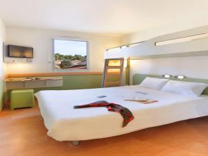 Postel nebo postele na pokoji v ubytování First Inn Hotel