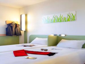 Postel nebo postele na pokoji v ubytování First Inn Hotel