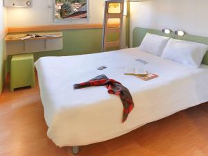 Postel nebo postele na pokoji v ubytování First Inn Hotel