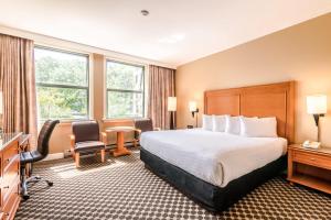 a hotel room with a bed and a desk at The Sylvia Hotel in Vancouver