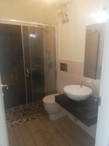 a bathroom with a shower and a sink and a toilet at Il Casalino Apartment in Pizzo