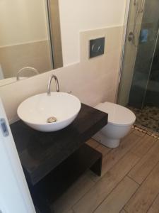 a bathroom with a sink and a toilet at Il Casalino Apartment in Pizzo