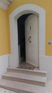 a hallway with a white door and stairs at Il Casalino Apartment in Pizzo