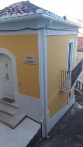 a small building with a door and a staircase at Il Casalino Apartment in Pizzo