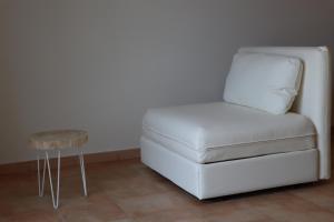 a white chair and a table in a room at Myricae in Viareggio