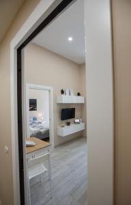 a room with a mirror and a table and a desk at Casa Cavaliere in Naples