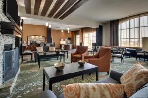 a hotel lobby with couches and chairs and a fireplace at Staybridge Suites - Rock Hill by IHG in Rock Hill