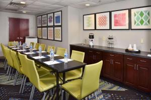 a conference room with a long table and yellow chairs at Holiday Inn Express Hotel & Suites Selma, an IHG Hotel in Selma