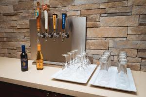 a counter with glasses and bottles of wine on it at Staybridge Suites - Newark - Fremont, an IHG Hotel in Newark