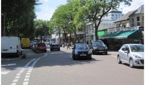 a busy city street with cars driving down the road at Rooftops Apartment in Bletchley