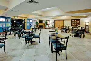 a dining room with tables and chairs at Holiday Inn Express Hotel & Suites Suffolk, an IHG Hotel in Suffolk