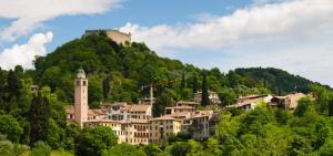 a town on a hill with a castle on a mountain at GrappaLand in Crespano del Grappa