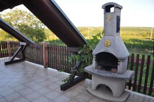 a stone pizza oven sitting on a patio at Sklípek u kapličky in Velké Bílovice