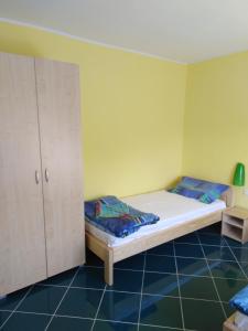 a small bedroom with a bed and a cabinet at Apartman Silvana in Rudnik Kačerski +13 photos