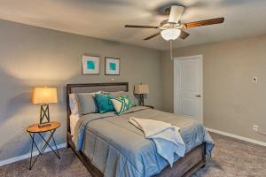 a bedroom with a bed with a ceiling fan at Family Home with Yard Less Than 1 Mi to Cowboys Stadium in Arlington