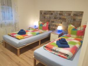 two beds in a room with towels on them at Casa Colori Rheinfelden in Herten