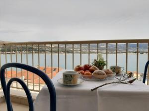 a table with a bowl of fruit on a balcony at Apartment Jelena in Trogir