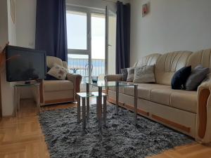 a living room with a couch and a tv at Apartment Jelena in Trogir