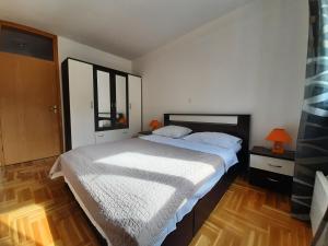 a bedroom with a large white bed in it at Apartment Jelena in Trogir