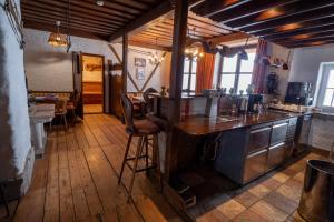 a kitchen with a counter and a bar in a room at Almhaus Dachsteinblick am Feuerkogel in Ebensee +26 photos