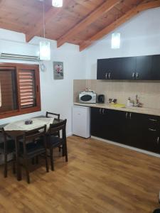 a kitchen with a table and chairs in a room at Orr Halevana in Bruchim Qela' Alon