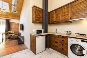 a kitchen with a washing machine and a dining room at Raven Suites Old City Istanbul in Istanbul