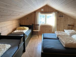 מיטה או מיטות בחדר ב-Løstegård Hytter