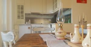 a kitchen with a table with a vase on it at Holiday house VilAna in Puconci +18 photos