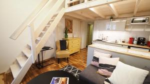 ein Wohnzimmer mit einer Treppe und eine Küche in der Unterkunft Apartamenty Stary Rzeszów in Rzeszów