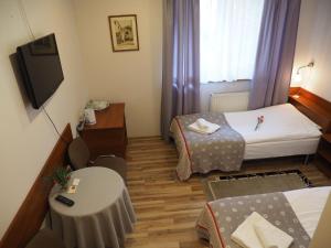 a small room with two beds and a television at Dom Gościnny 8 km od Suntago, Deepspot in Radziejowice