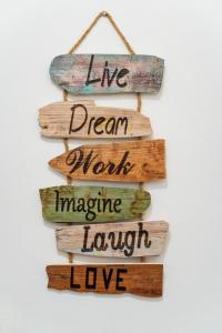 a sign that says live dream more imagine laugh love at Casa Io - Bica in Mindelo