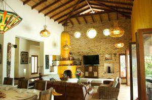 a dining room with a fireplace and a brick wall at Casa Mar Verde in Armenia