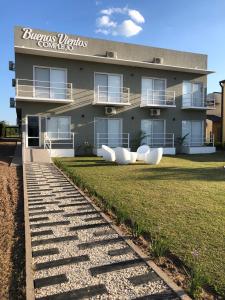 a building with a lawn in front of it at Buenos Vientos Complejo - Termas Chajarí in Chajarí