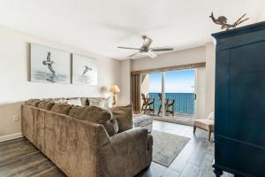 a living room with a couch and a view of the ocean at Tidewater Condominiums in Orange Beach