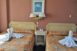 Postel nebo postele na pokoji v ubytování Hotel María Teresa