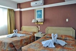 Postel nebo postele na pokoji v ubytování Hotel María Teresa