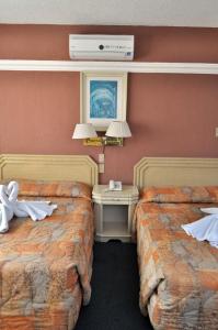 Postel nebo postele na pokoji v ubytování Hotel María Teresa