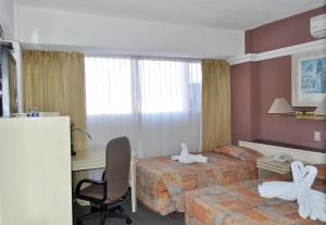 Postel nebo postele na pokoji v ubytování Hotel María Teresa