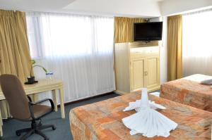 Postel nebo postele na pokoji v ubytování Hotel María Teresa