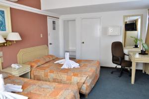 Postel nebo postele na pokoji v ubytování Hotel María Teresa