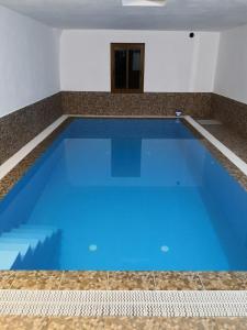 a large blue swimming pool in a room at Live Masca - Estudio casas morrocatana Tenerife in Masca