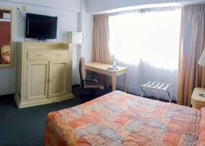 Postel nebo postele na pokoji v ubytování Hotel María Teresa