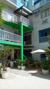 a building with a green tower with a table and umbrella at MR Holidays Hotel in Boracay