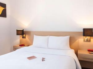 Postel nebo postele na pokoji v ubytování Aparthotel Adagio Access Saint Louis Bâle