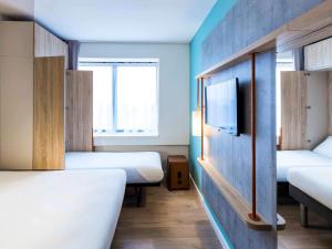 Giường trong phòng chung tại ibis budget Amsterdam City South