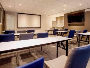 a classroom with tables and chairs and a projection screen at ibis Lima Reducto Miraflores in Lima