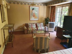 a living room with a couch and a table at Hotel Foresta in Santiago