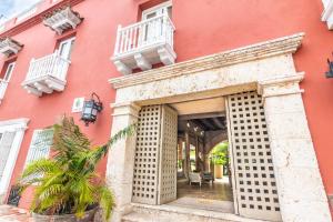 an entrance to a building with a red building at GHL Collection Armería Real Hotel in Cartagena de Indias +113 photos