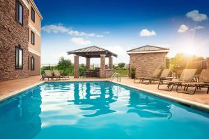 a swimming pool with chairs and a gazebo at Staybridge Suites West Fort Worth, an IHG Hotel in Fort Worth